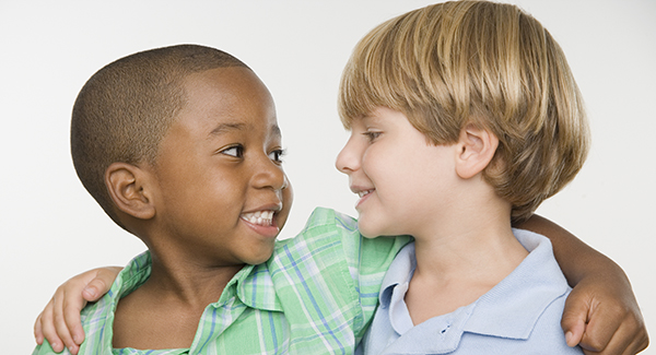 Two young boys smiling at each other